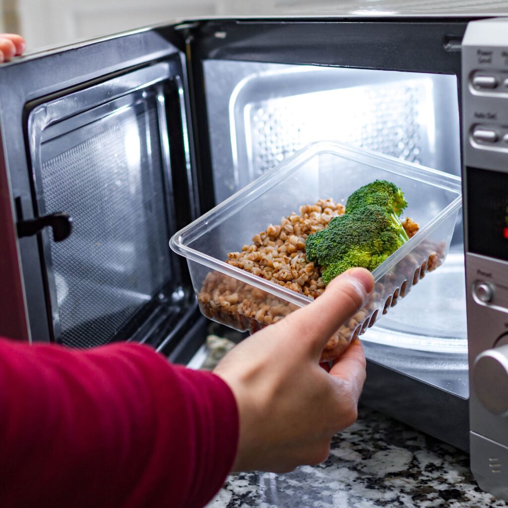 Thinwall container with food going into a microwave