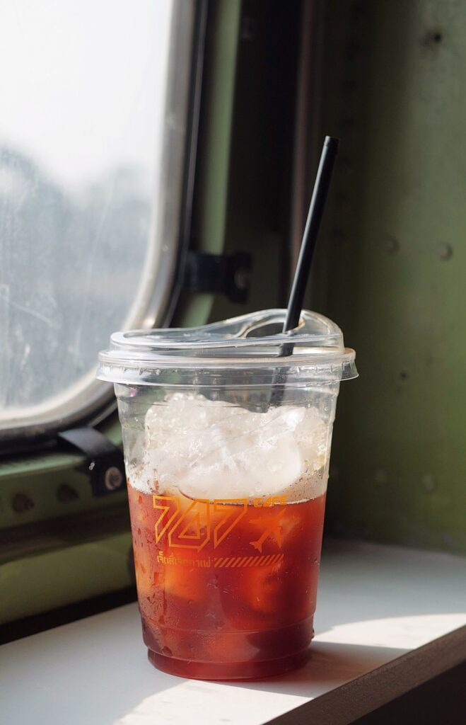 Iced coffee in a clear plastic cup with a straw