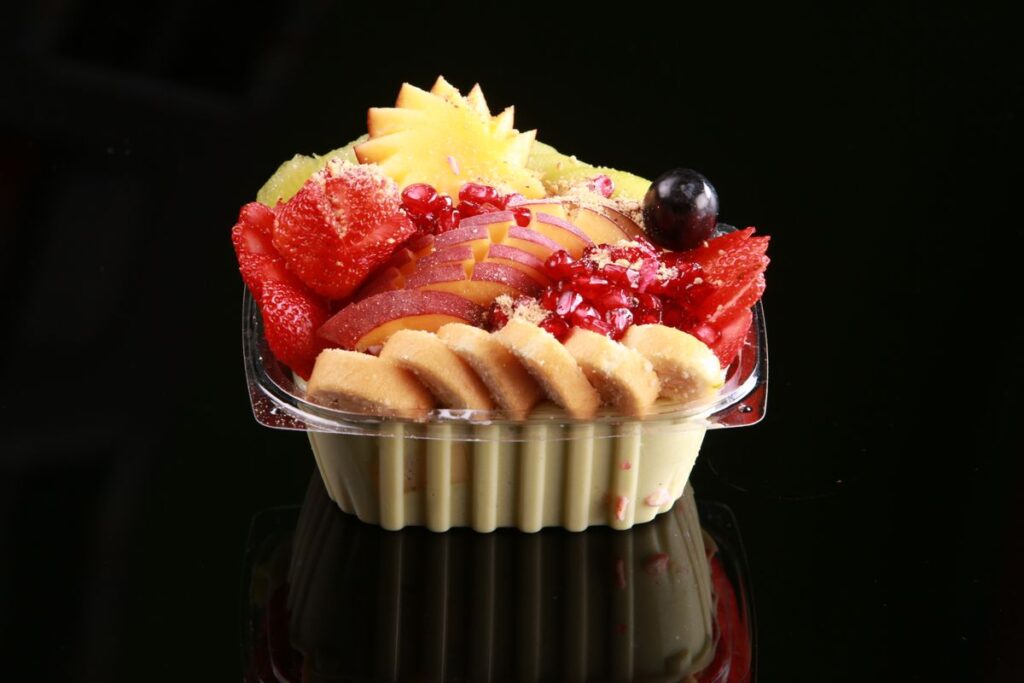 Fruit salad in a clear plastic bowl